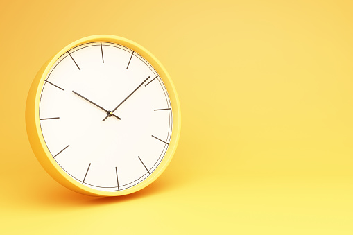 picture of a clock with a yellow background