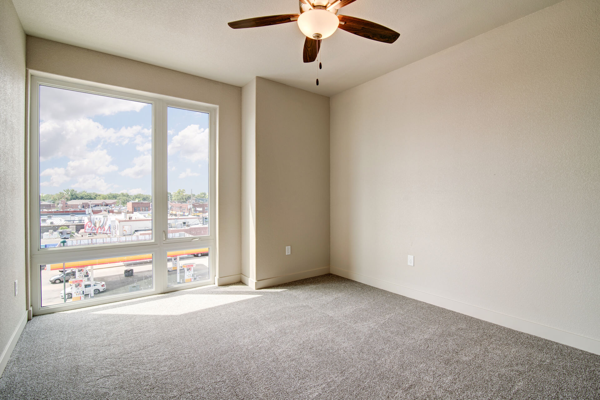 interior of an empty apartment at 12b lofts with a ceiling fan