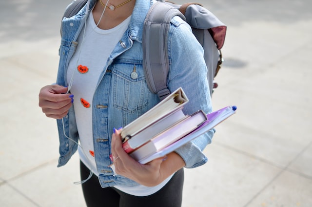 college student with a backpack on carrying her books